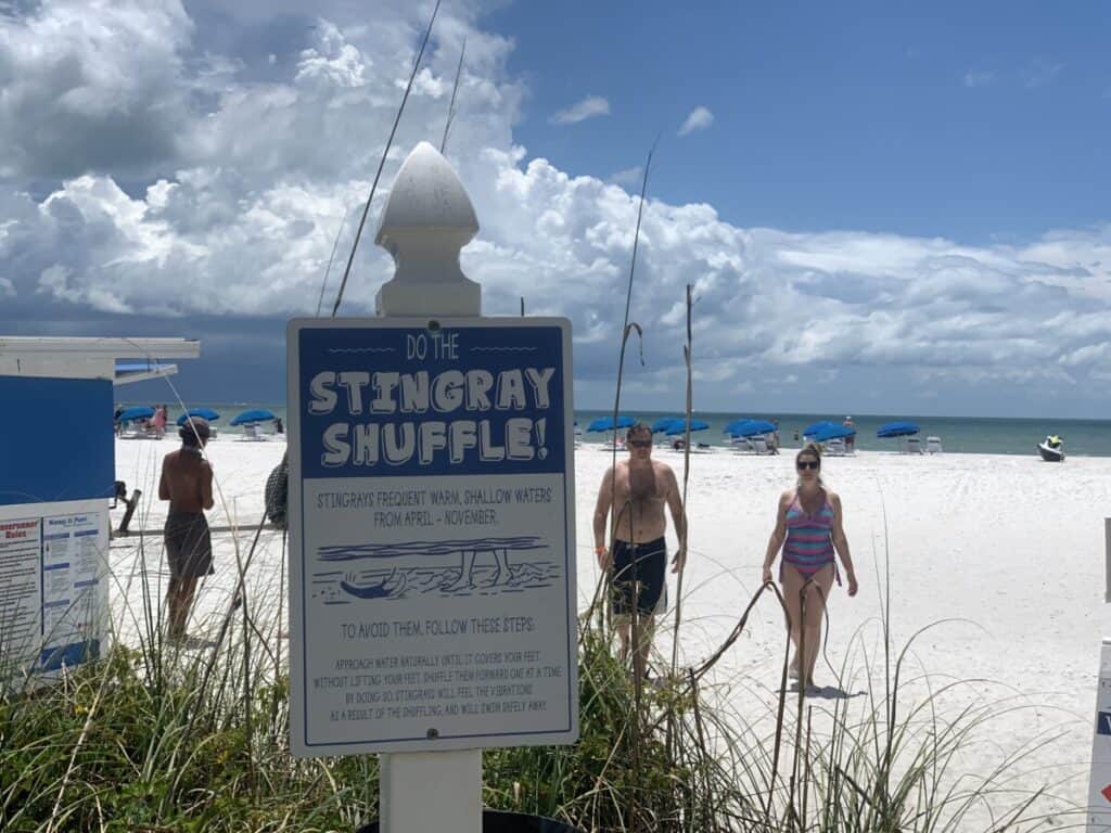 Image of Stingray Shuffle sign, white beach, and Gulf of Mexico